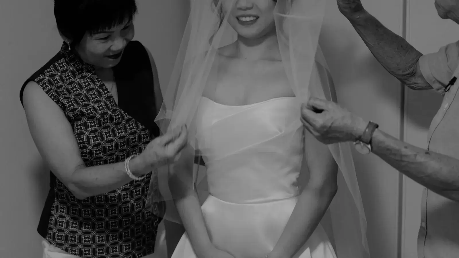 Bride veiling with her parents during the family blessing at home