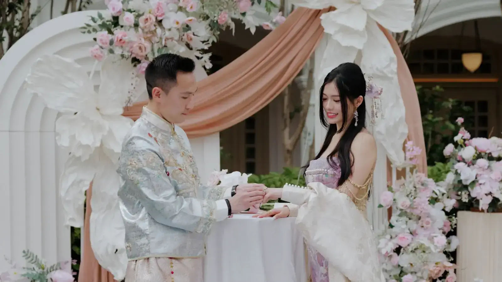 Emotional wedding rings exchange at Raffles Hotel Lawn